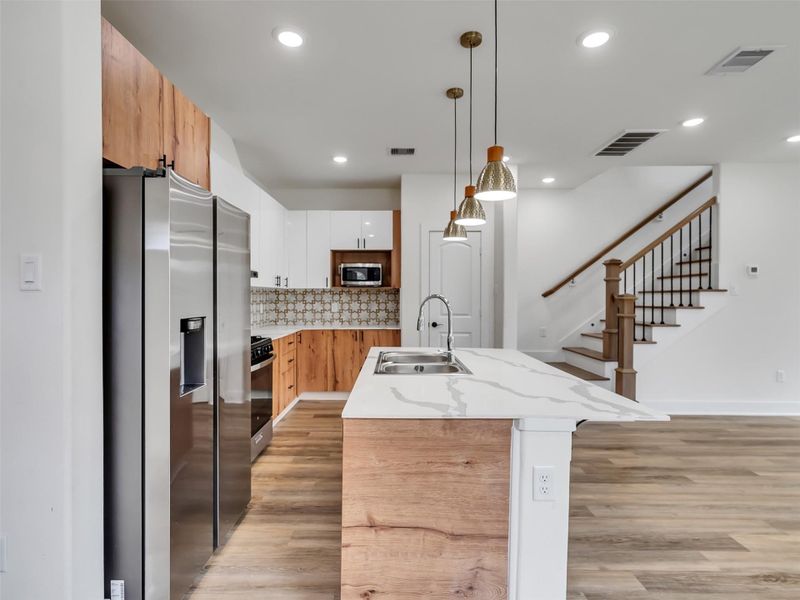 Kitchen area well appointed with designer backsplash and stainless steel appliances. Kitchen area well appointed with designer backsplash and stainless steel appliances.