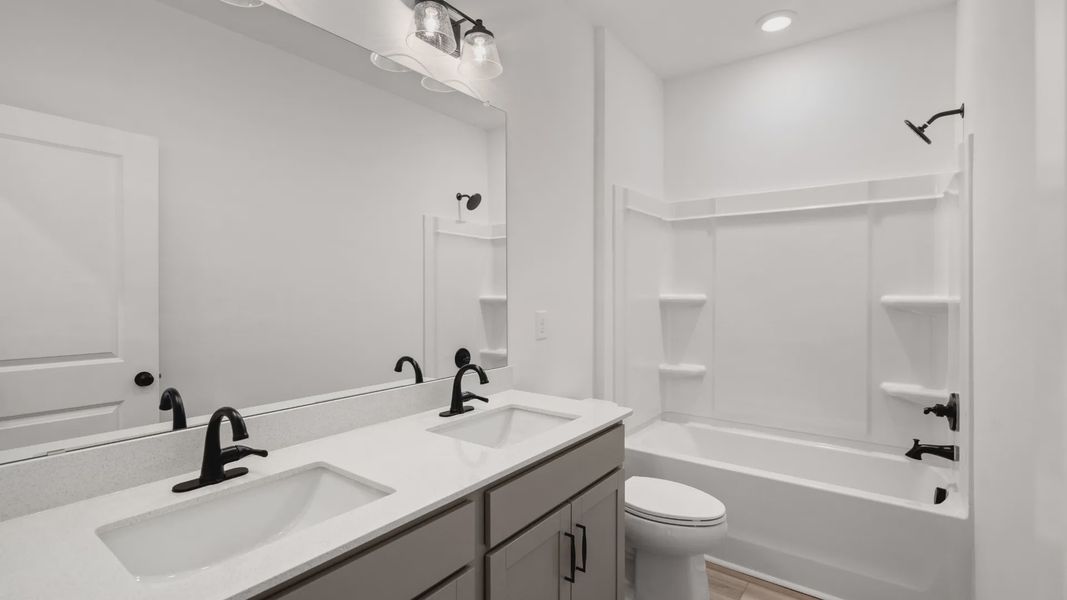 The Easton plan’s secondary bathroom includes a dual-sink vanity and a tub-shower combination.