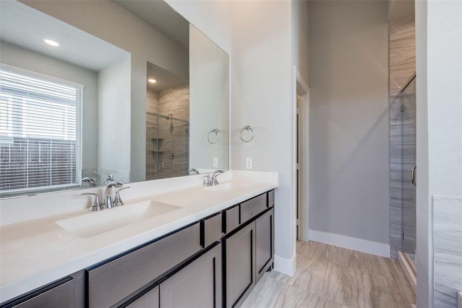 Bathroom with a shower stall and double vanity