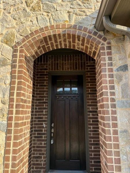 Doorway to property with brick siding Doorway to property with brick siding