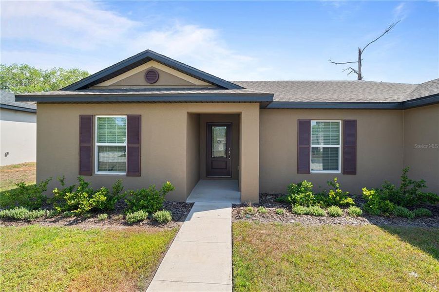 Front exterior of a new home in Poinciana, Poinciana, FL, highlighting curb appeal (Image 13).