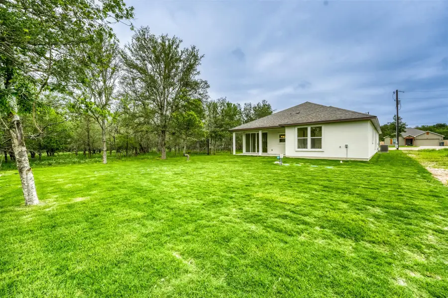 Expansive backyard with mature trees and plenty of room to relax, entertain, or play