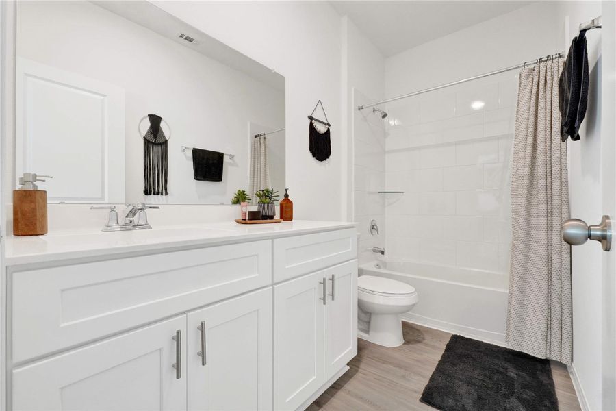 The secondary bedrooms are bright and versatile, ideal for guests, children, or a home office, complemented by a stylish full bathroom designed with modern finishes and thoughtful details.