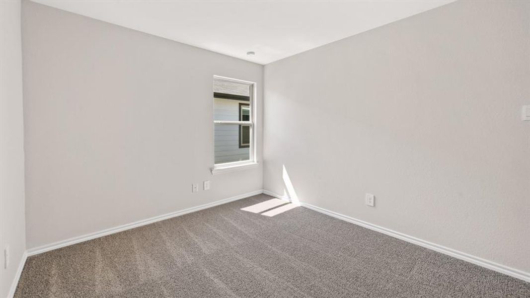 Neutral-toned walls complement the gray carpeting