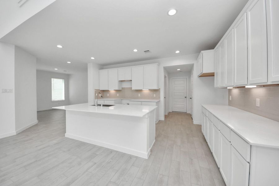 All of this overlooks your expansive family room, creating a perfect space for culinary delights and family gatherings. Sample photo of completed home with similar floor plan. Actual colors and selections may vary.