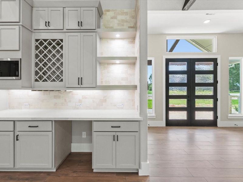 Stylish kitchen cabinets feature under-shelf lighting, space for a wine or mini fridge. Stylish kitchen cabinets feature under-shelf lighting, space for a wine or mini fridge.