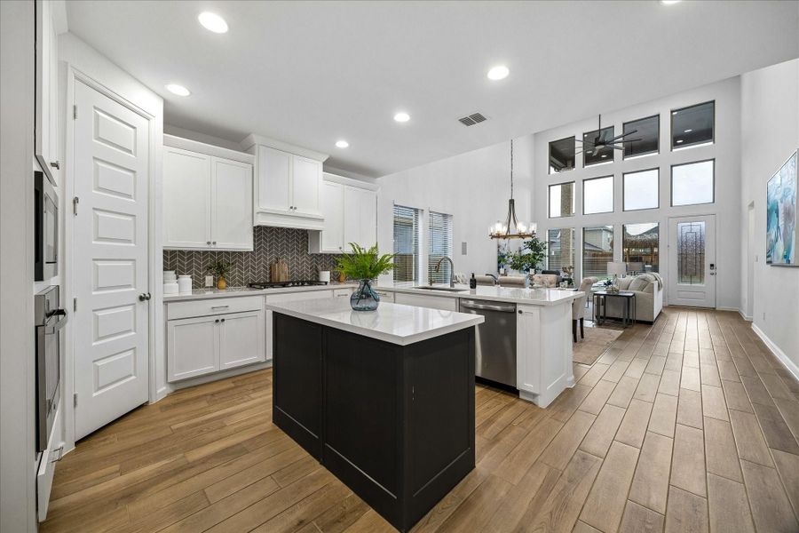 The foyer opens beautifully to a spectacular island kitchen, open dining area, and spacious family room designed for easy everyday living. It’s a layout that invites quiet mornings, lazy weekends, lively gatherings, and all the moments in between.