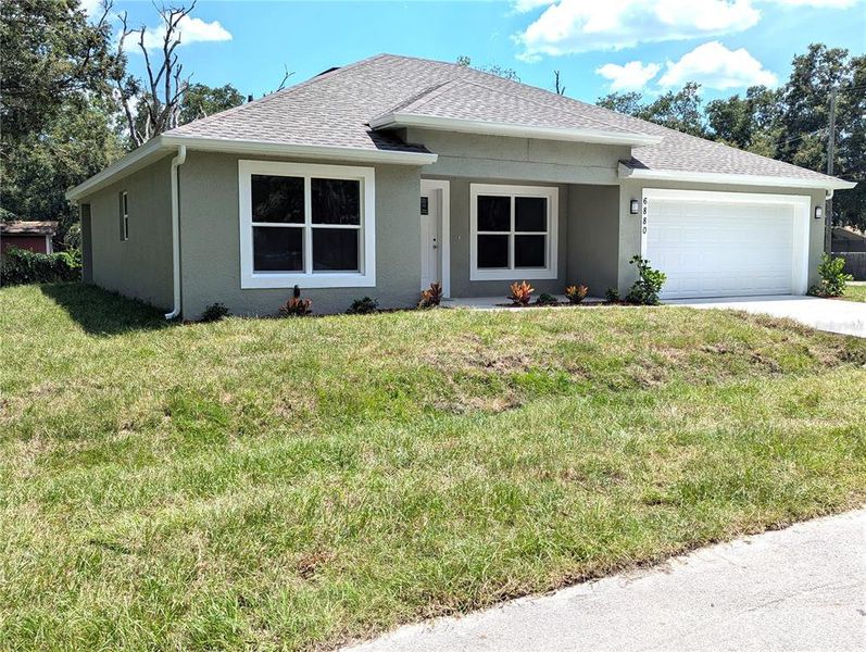 Front exterior of a new home in , Mulberry, FL, highlighting curb appeal (Image 1).