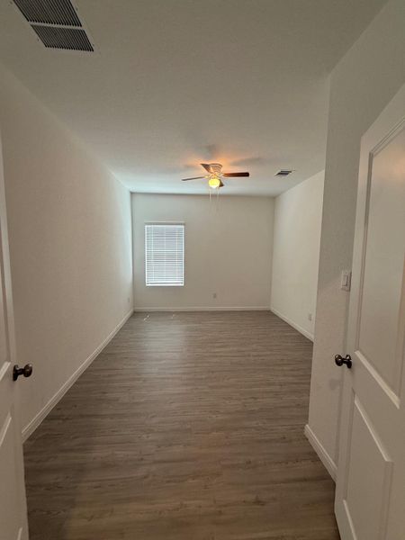 A quiet, well-lit space features durable wood-look flooring and a ceiling fan for comfort.