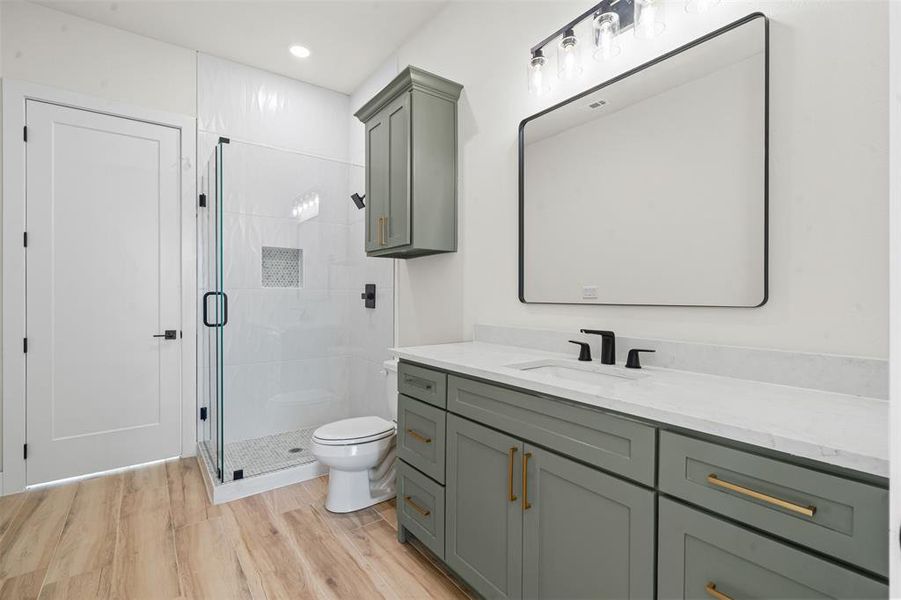 Full bathroom with vanity, a shower stall, light wood finished floors, and recessed lighting Full bathroom with vanity, a shower stall, light wood finished floors, and recessed lighting