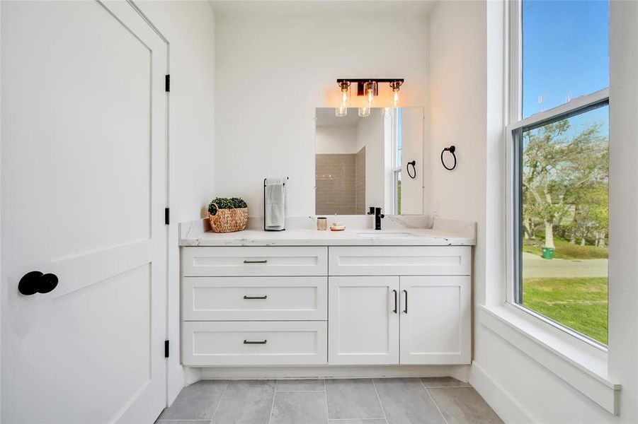 This photo was taken in another staged property with the same finishes and layout. Secondary Bathroom. There is a full size mirror in this bathroom in the Oxford homes.