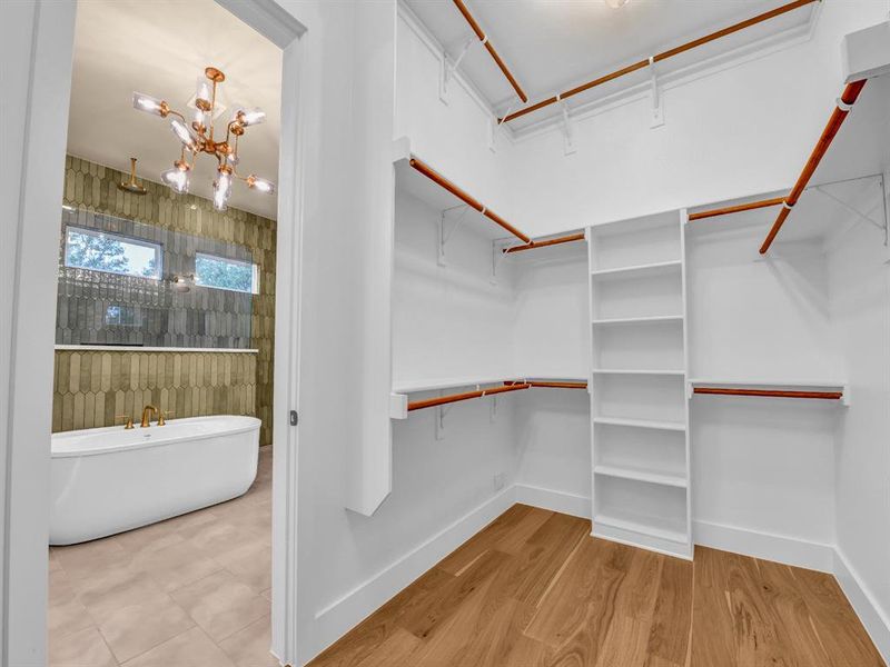 Spacious closet with an inviting chandelier