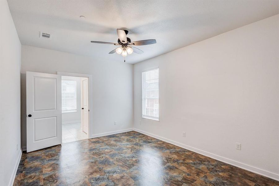 Unfurnished room featuring tile patterned flooring and ceiling fan