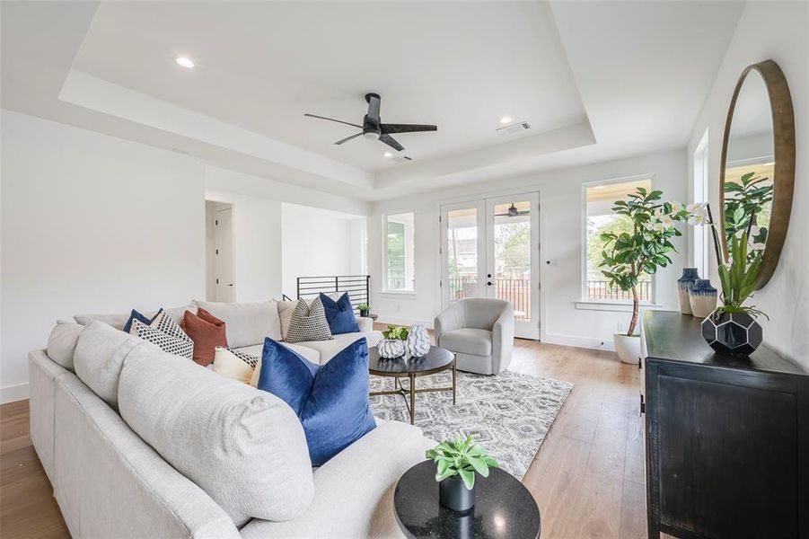Second floor Living room with a raised ceiling, french doors, light wood-style flooring, recessed lighting, and ceiling fan Second floor Living room with a raised ceiling, french doors, light wood-style flooring, recessed lighting, and ceiling fan