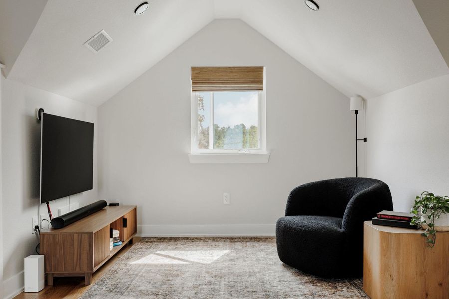 Sitting room with wood finished floors and baseboards
