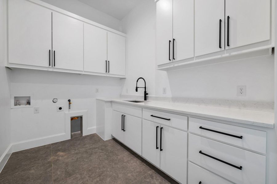 Laundry area featuring hookup for a gas dryer, cabinet space, washer hookup, and electric dryer hookup