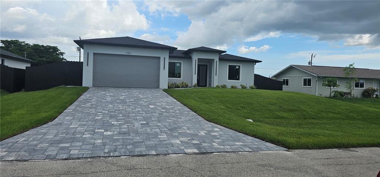 Front exterior of a new home in , Cape Coral, FL, highlighting curb appeal (Image 1). Front exterior of a new home in , Cape Coral, FL, highlighting curb appeal (Image 1).