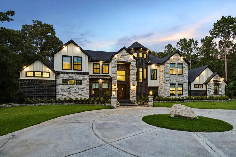 As you arrive, the home's striking exterior immediately commands attention. A timeless blend of premium brick, natural stone, dramatic rooflines, and elegant architectural details creates exceptional curb appeal. The oversized three-car garage complements the home's sophisticated design while providing outstanding functionality. Every exterior finish reflects the quality craftsmanship and attention to detail that continue throughout the entire residence.