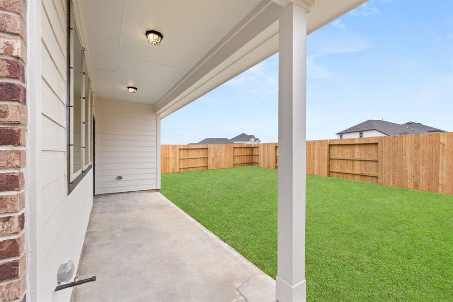 The covered patio is generously sized, providing ample space for various outdoor activities.