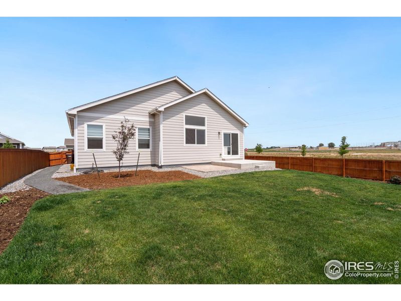 Side yard has crushed stone walkway and service door off side of garage for easy access; over $8k in landscaping spent in past year