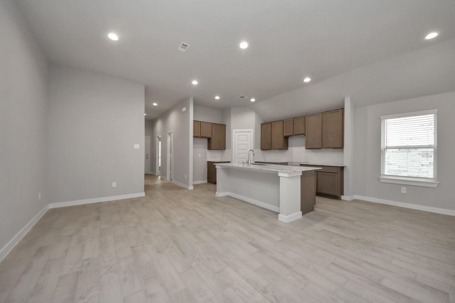 Discover this stunning view of the kitchen and dining area seamlessly connected to create an open concept feel. Sample photo of completed home with similar floor plan. Actual colors and selections may vary.