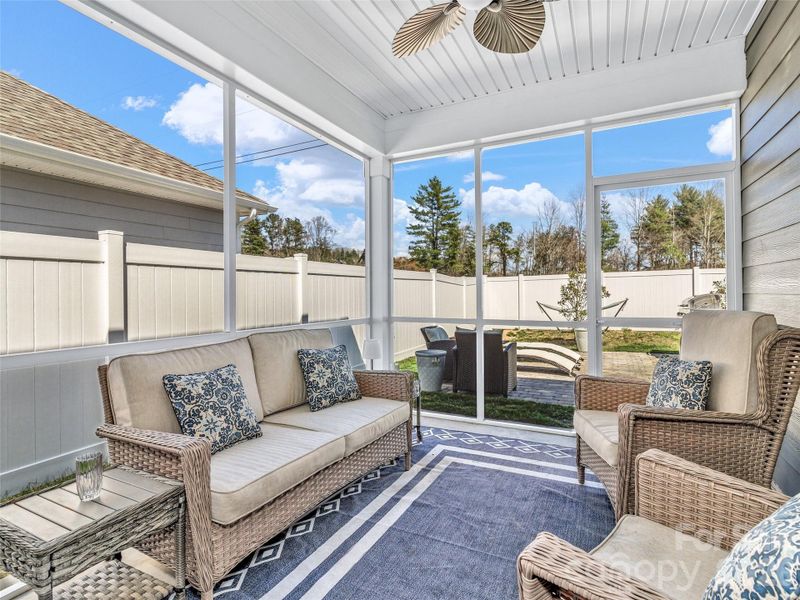 Screen porch opens to level backyard that is fully fenced.