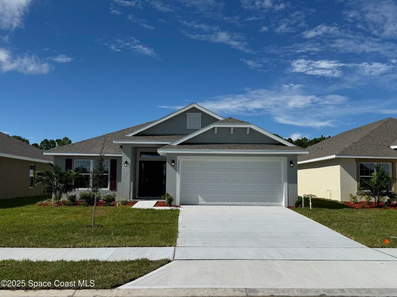 Front exterior of a new home in St. John Preserve, Palm Bay, FL, highlighting curb appeal (Image 1). Front exterior of a new home in St. John Preserve, Palm Bay, FL, highlighting curb appeal (Image 1).