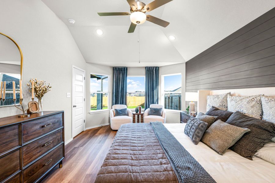 Primary bedroom in the model home located in Carillon at 13305 Eppright Trace Blvd., Manor, TX Primary bedroom in the model home located in Carillon at 13305 Eppright Trace Blvd., Manor, TX