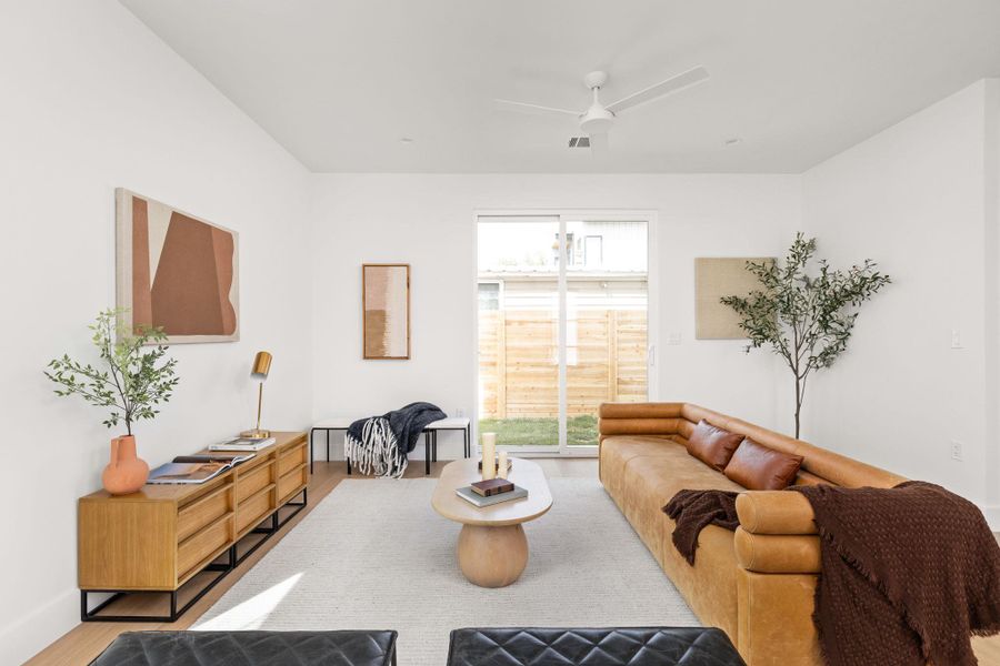 Living room with ceiling fan and wood finished floors