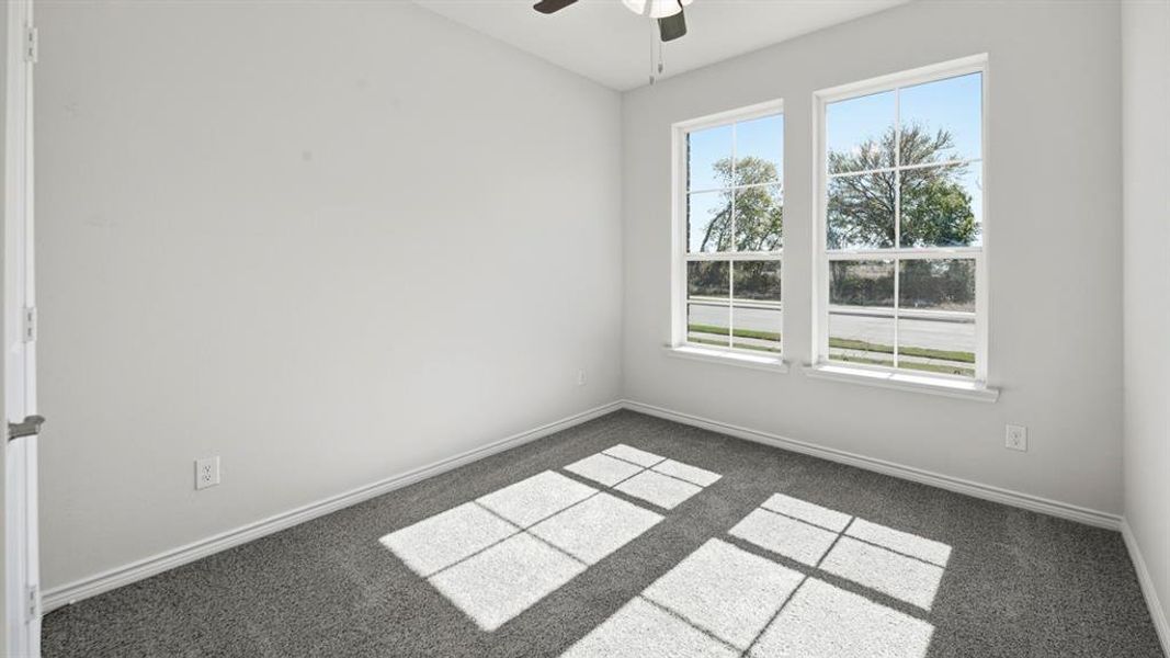 Spare room featuring ceiling fan and carpet flooring Spare room featuring ceiling fan and carpet flooring