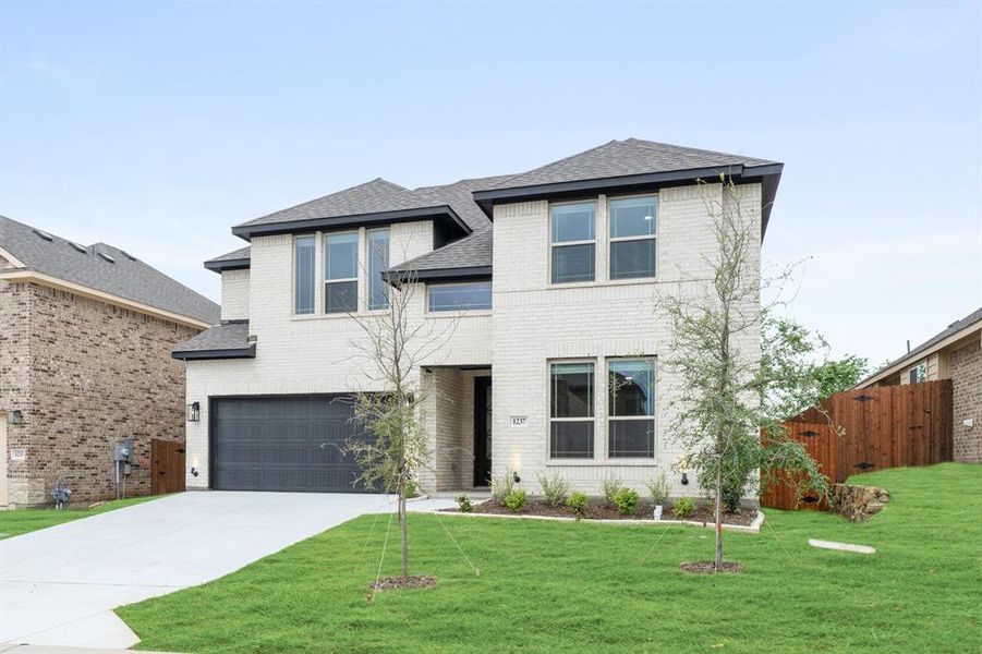 Front exterior of a new home in Star Ranch, Godley, TX, highlighting curb appeal (Image 2).
