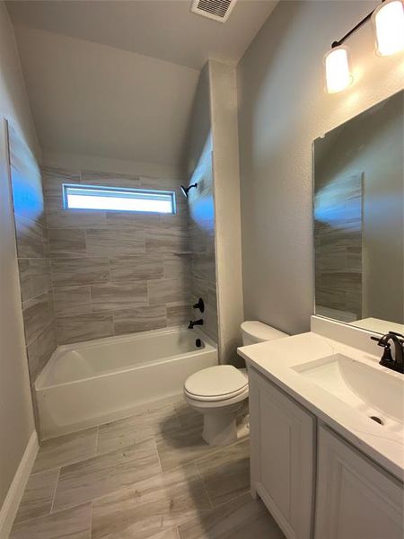 Bath 2 with window has 12x24 tile, white cabinets & Calacatta Lincoln quartz. Bath 2 with window has 12x24 tile, white cabinets & Calacatta Lincoln quartz.