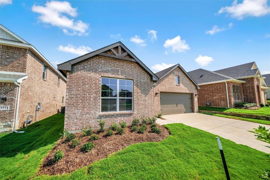 Front exterior of a new home in Liberty Pointe, Gainesville, TX, highlighting curb appeal (Image 21). Front exterior of a new home in Liberty Pointe, Gainesville, TX, highlighting curb appeal (Image 21).
