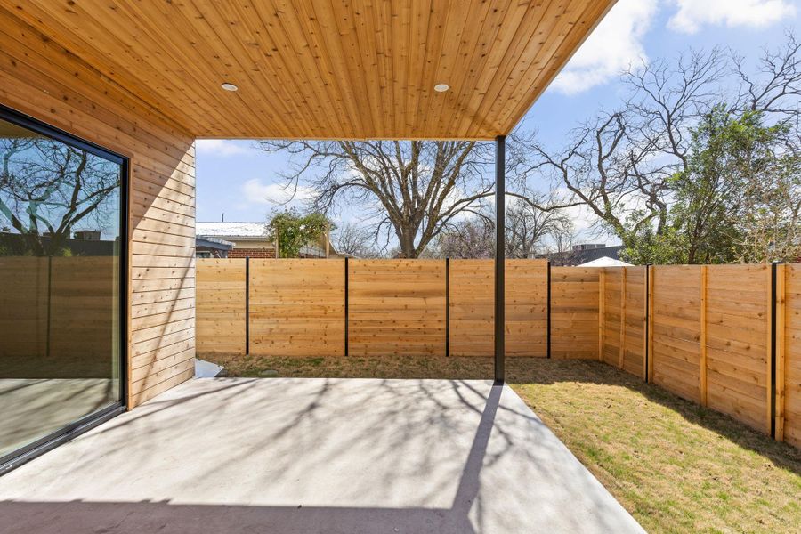 View of patio with a fenced backyard