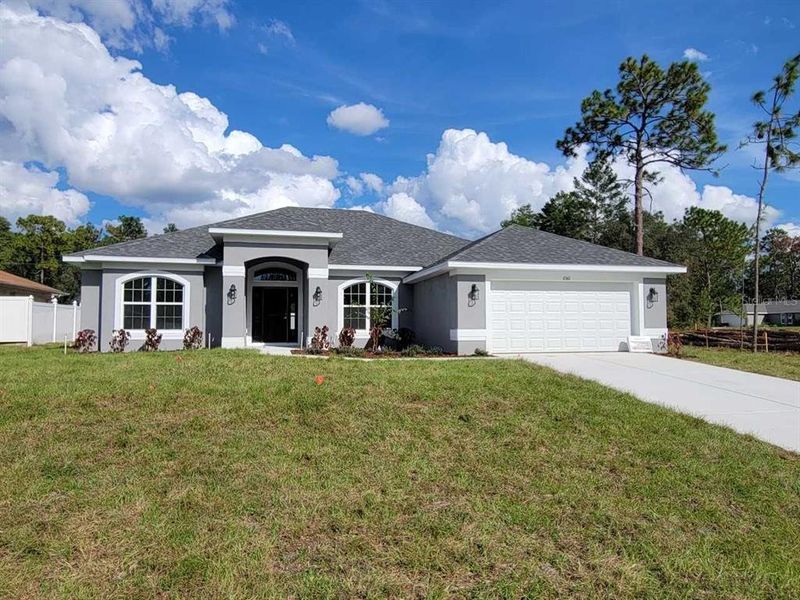Front exterior of a new home in Marion Oaks, Ocala, FL, highlighting curb appeal (Image 2).
