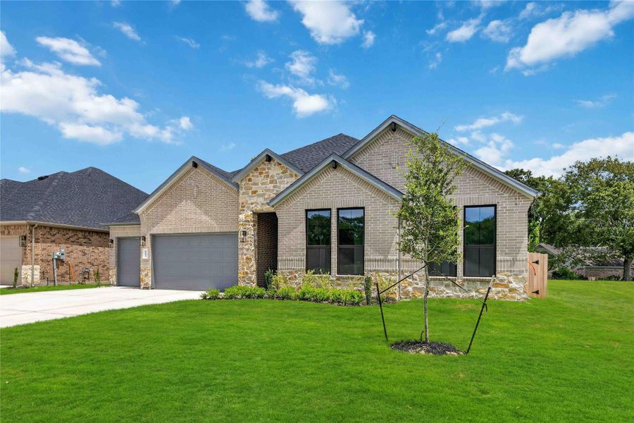 Front exterior of a new home in Friendswood Trails 70' Homesites, Friendswood, TX, highlighting curb appeal (Image 2).