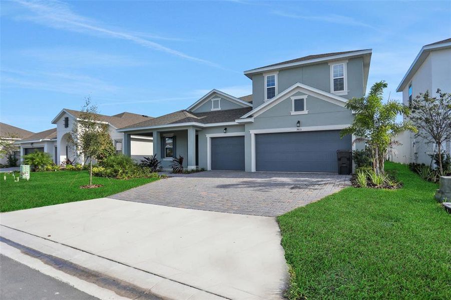 Front exterior of a new home in Seaire, Parrish, FL, highlighting curb appeal (Image 20).