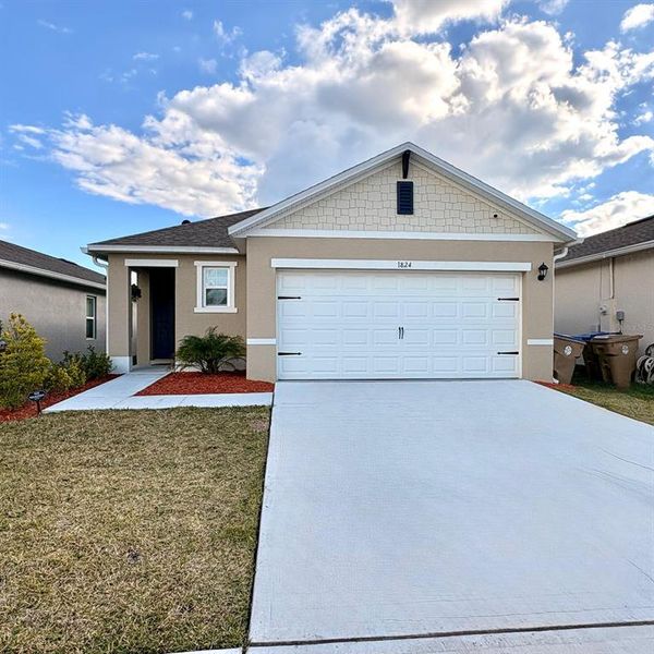 Front exterior of a new home in Kindred, Kissimmee, FL, highlighting curb appeal (Image 17).