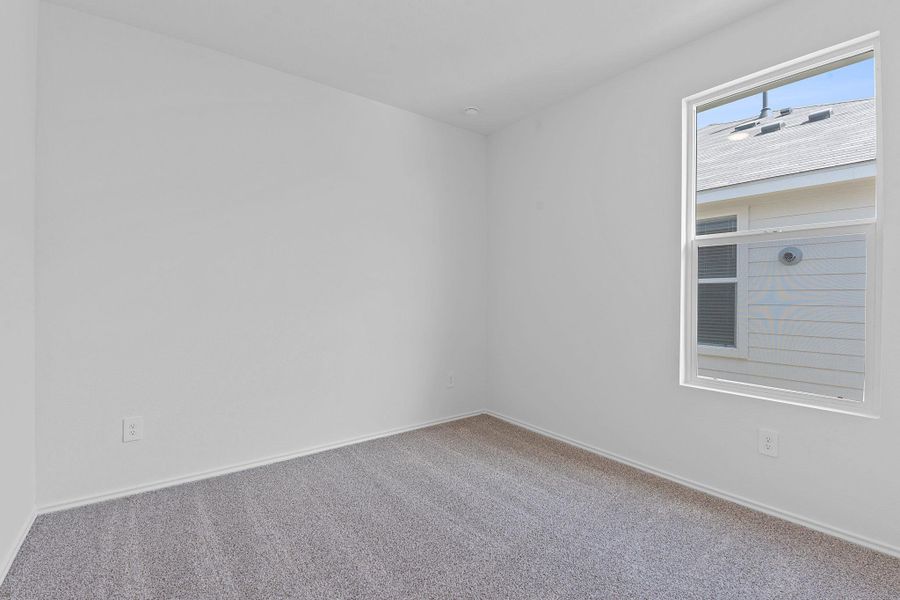 Carpeted empty room with baseboards