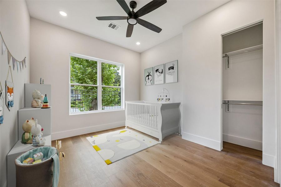 Elevated ceilings and oversized windows help the secondary bedroom feel larger than its footprint suggests. The layout leaves flexibility for guests, office space, or additional everyday living needs. (digitally staged) Elevated ceilings and oversized windows help the secondary bedroom feel larger than its footprint suggests. The layout leaves flexibility for guests, office space, or additional everyday living needs. (digitally staged)