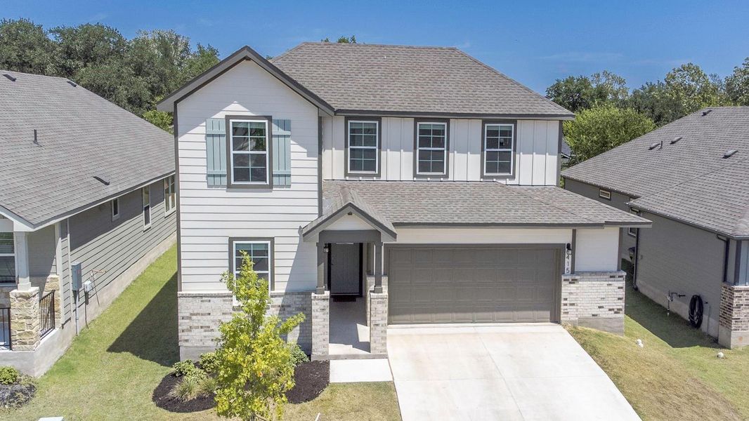 Front exterior of a new home in Brooks Ranch, Kyle, TX, highlighting curb appeal (Image 27).