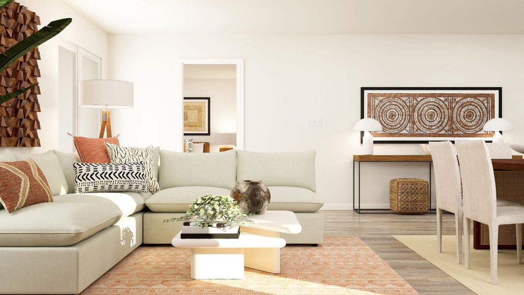 A living room with a white couch and a table.