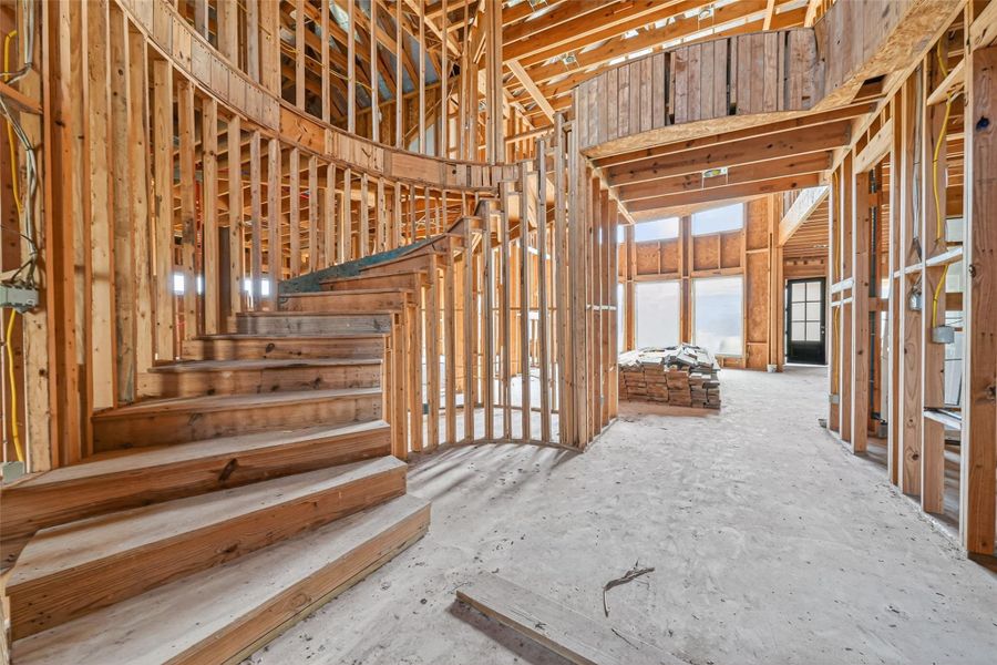 Open unfinished space showcasing framing and build progress.