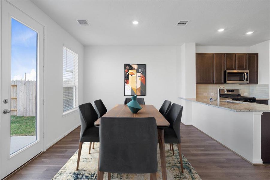 Start your day off right with a cup of coffee sitting with your family in the lovely dining area! Featuring a large window with blinds, custom paint and recessed lighting.