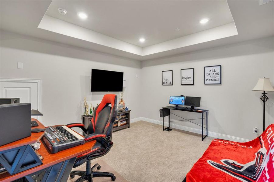 Recessed lighting illuminating a spacious room with light-colored carpeting
