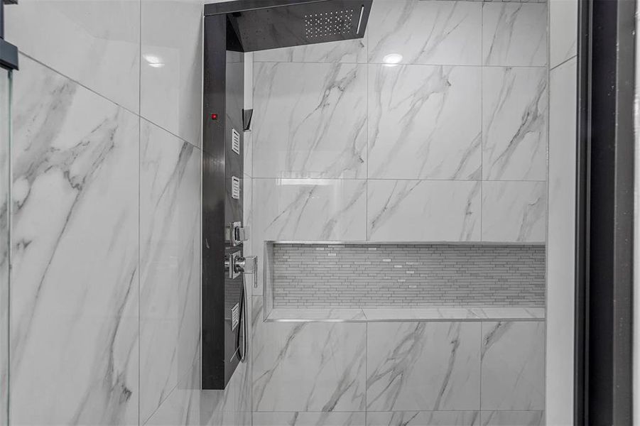 Interior details featuring a tile shower and elevator