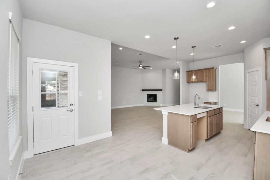 Discover another perspective of this stunning kitchen, generously appointed with an abundance of counter space. Sample photo of completed home with similar floor plan. Actual colors and selections may vary.