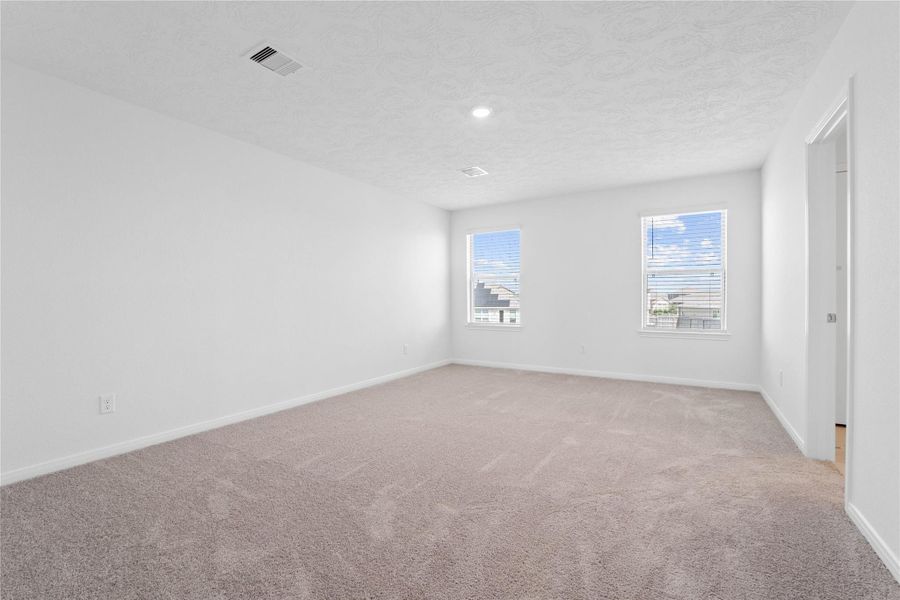 Relax and recharge in this stunning primary suite! This expansive room offers plush carpeting, neutral-toned walls, high ceilings, recessed lighting, and large windows fitted with privacy blinds—perfect for unwinding after a long day. Relax and recharge in this stunning primary suite! This expansive room offers plush carpeting, neutral-toned walls, high ceilings, recessed lighting, and large windows fitted with privacy blinds—perfect for unwinding after a long day.