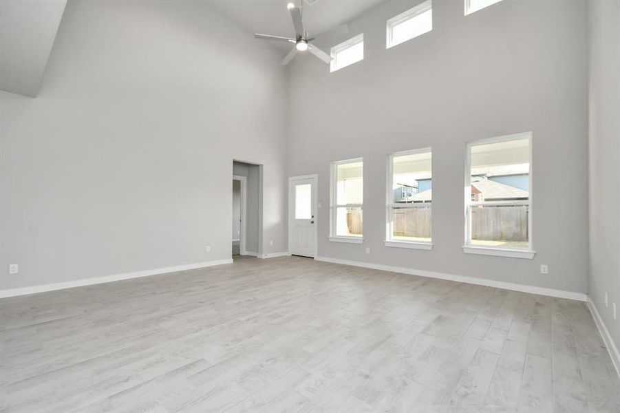 Take another glimpse into the heart of the home with this additional view of the family room—a sprawling space ready to accommodate all your gatherings. Sample photo of completed home with similar floor plan. As-built interior colors and selections may vary.