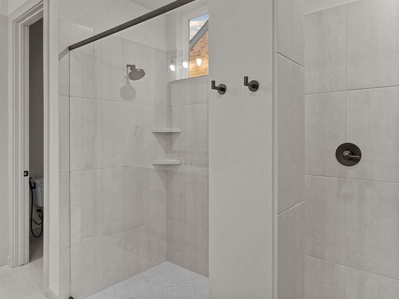 Master Bathroom with a tile shower